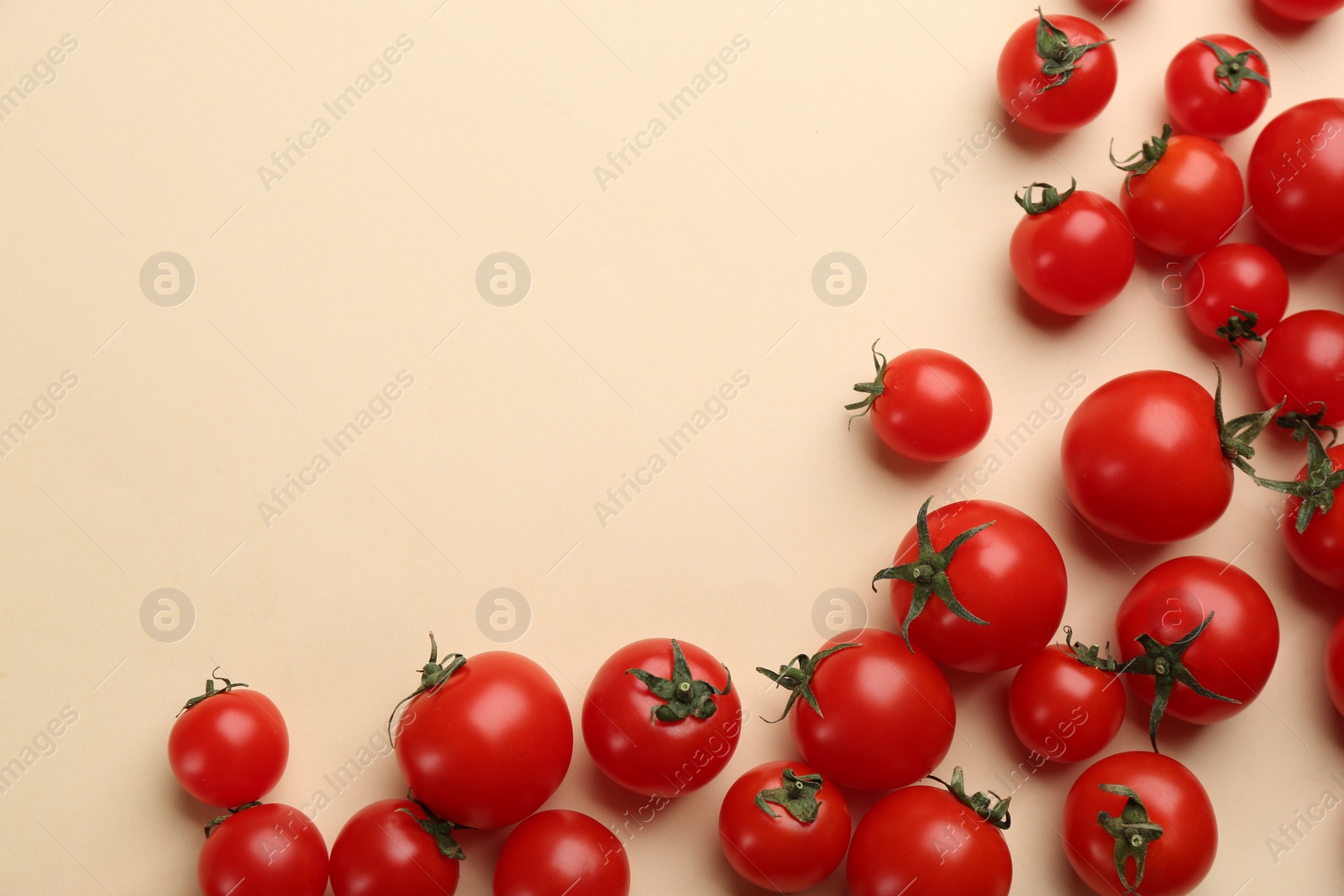 Photo of Fresh cherry tomatoes on beige background, flat lay. Space for text