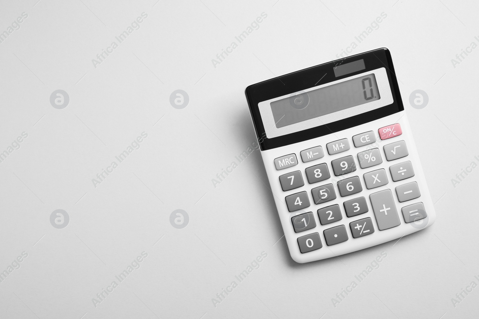 Photo of Calculator on light gray background, top view. Space for text