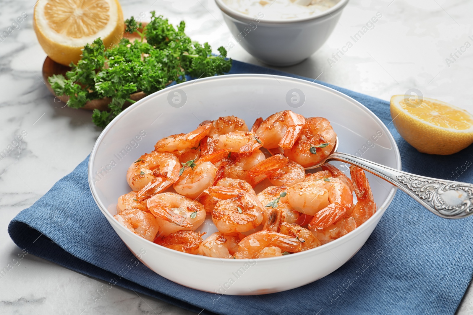 Photo of Bowl with delicious fried shrimps on table