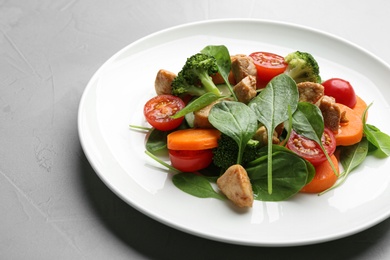 Delicious fresh chicken salad served on grey table, closeup