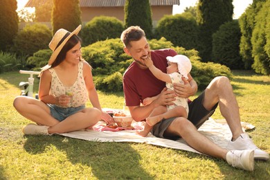 Photo of Happy family having picnic in garden on sunny day