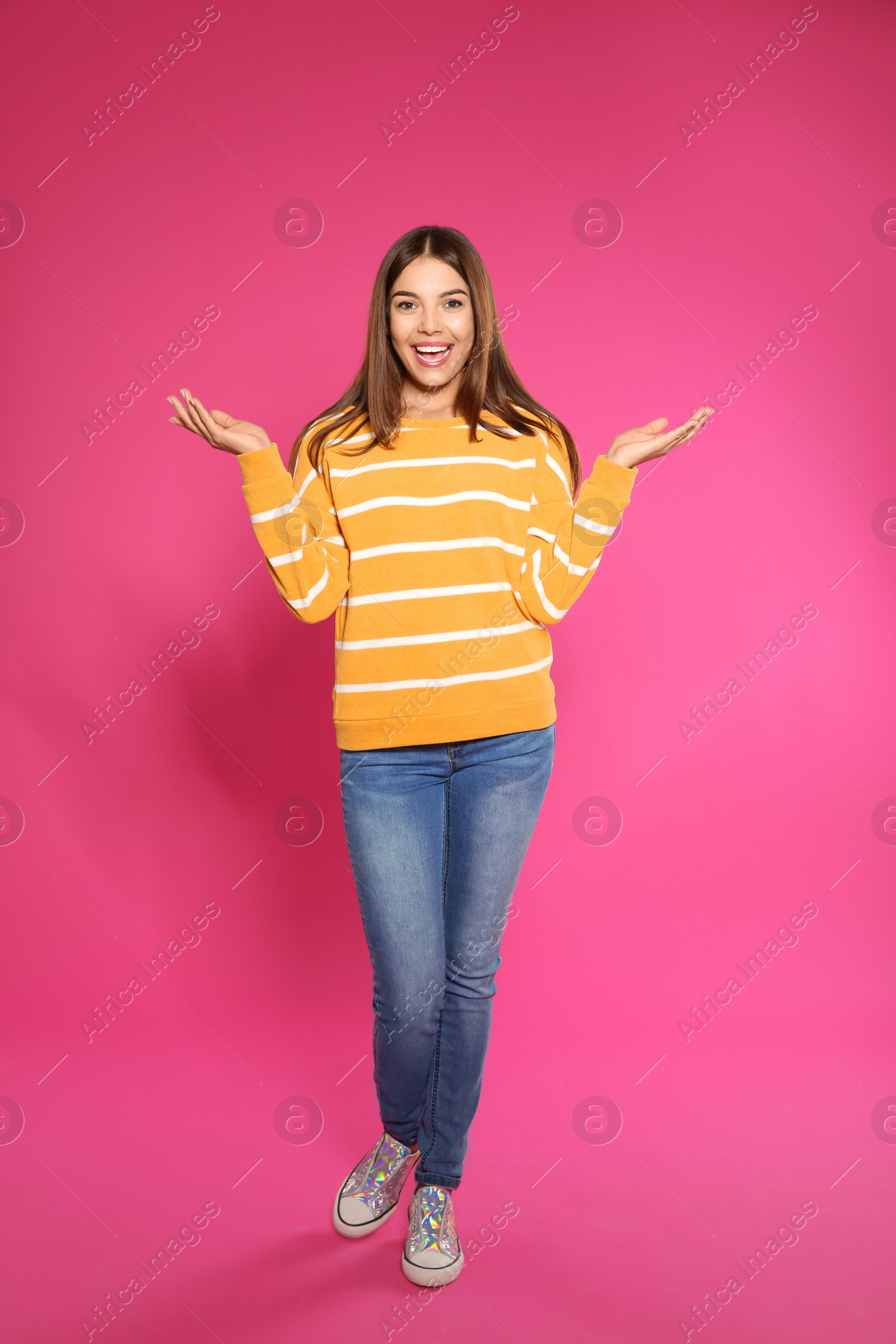 Photo of Full length portrait of emotional woman on color background