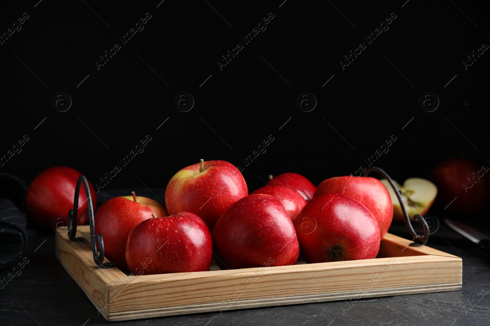 Photo of Fresh ripe red apples on black table