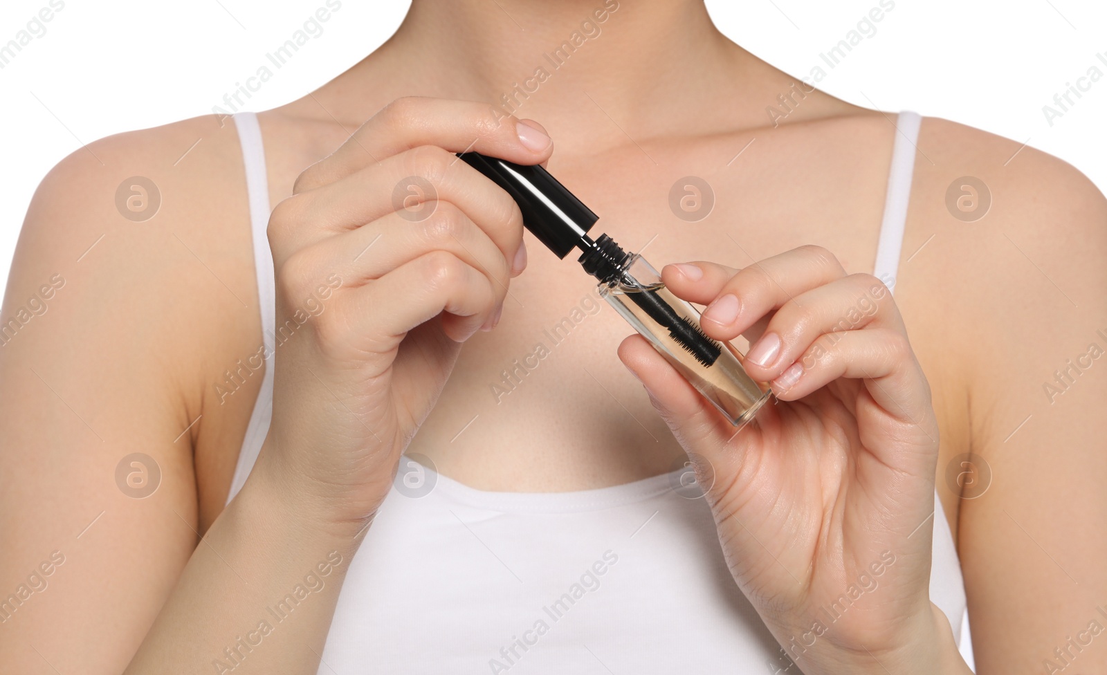Photo of Young woman with eyelash oil on white background, closeup