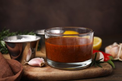 Photo of Fresh marinade and ingredients on wooden table, closeup