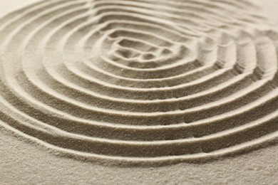 Photo of Beautiful spiral on sand, closeup. Zen garden