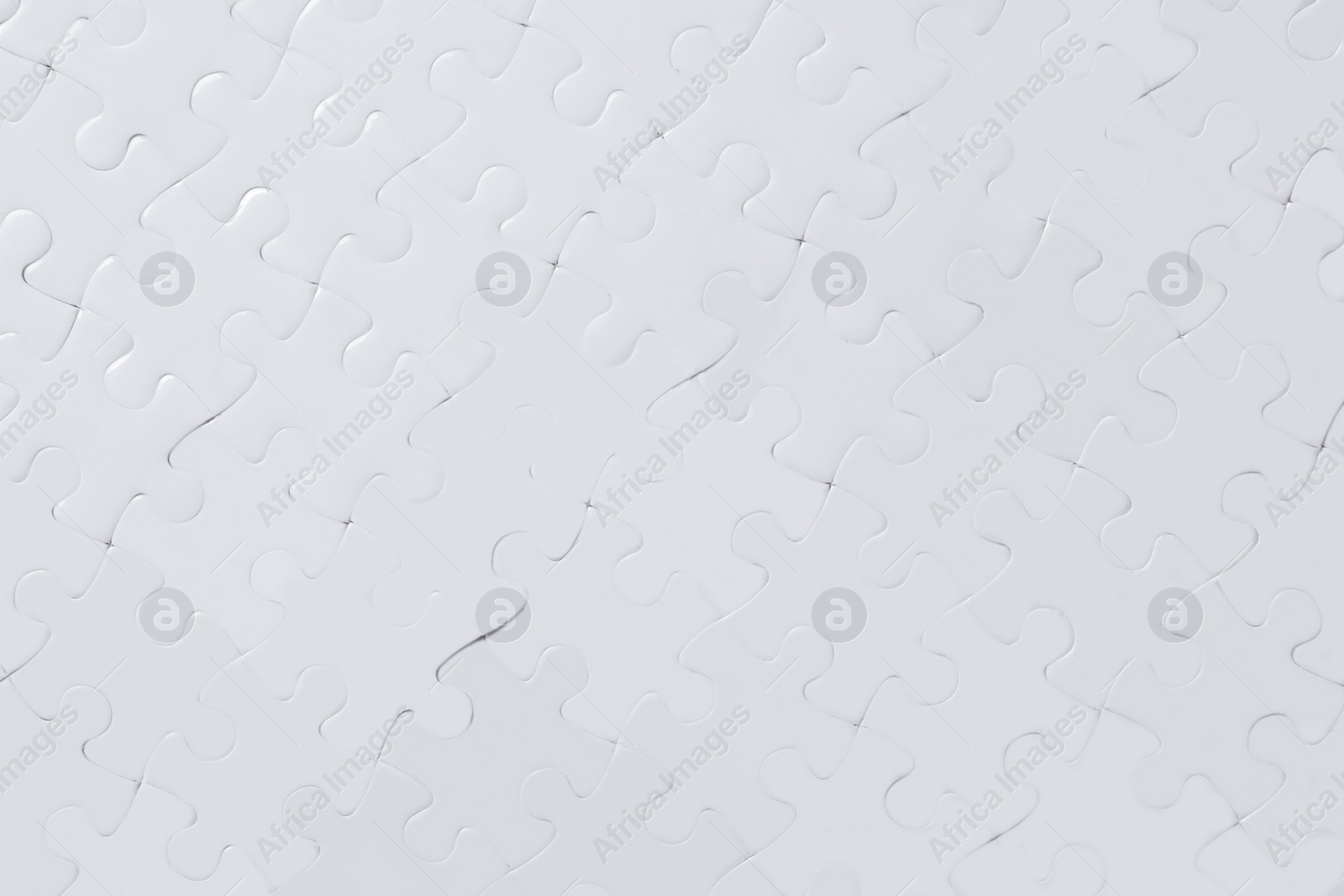 Photo of Blank white puzzle as background, top view