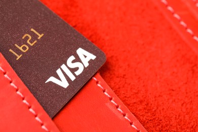 Photo of MYKOLAIV, UKRAINE - FEBRUARY 23, 2022: Bank card of Visa payment system in leather wallet, closeup