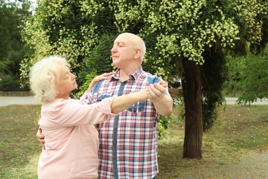 Photo of Cute elderly couple in love dancing outdoors