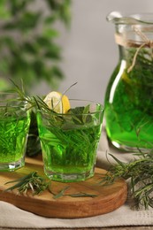 Refreshing tarragon drink with lemon slices on table