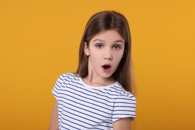 Photo of Portrait of surprised girl on yellow background