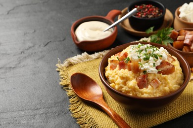 Photo of Delicious traditional Ukrainian banosh served on black table, space for text