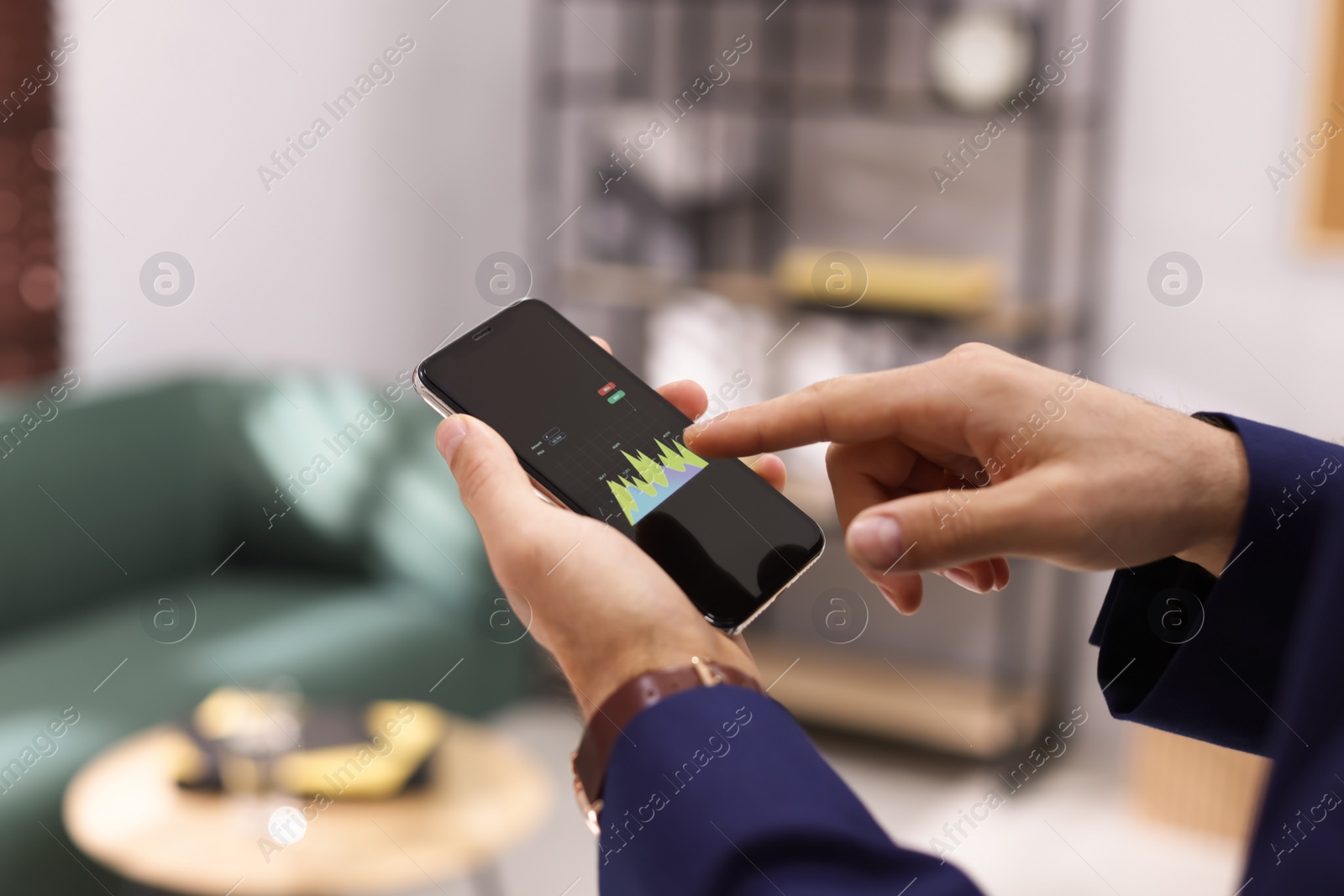 Photo of Businessman working with smartphone in office, closeup. Forex trading