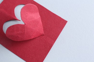 Photo of Red paper heart on gray background, above view. Space for text