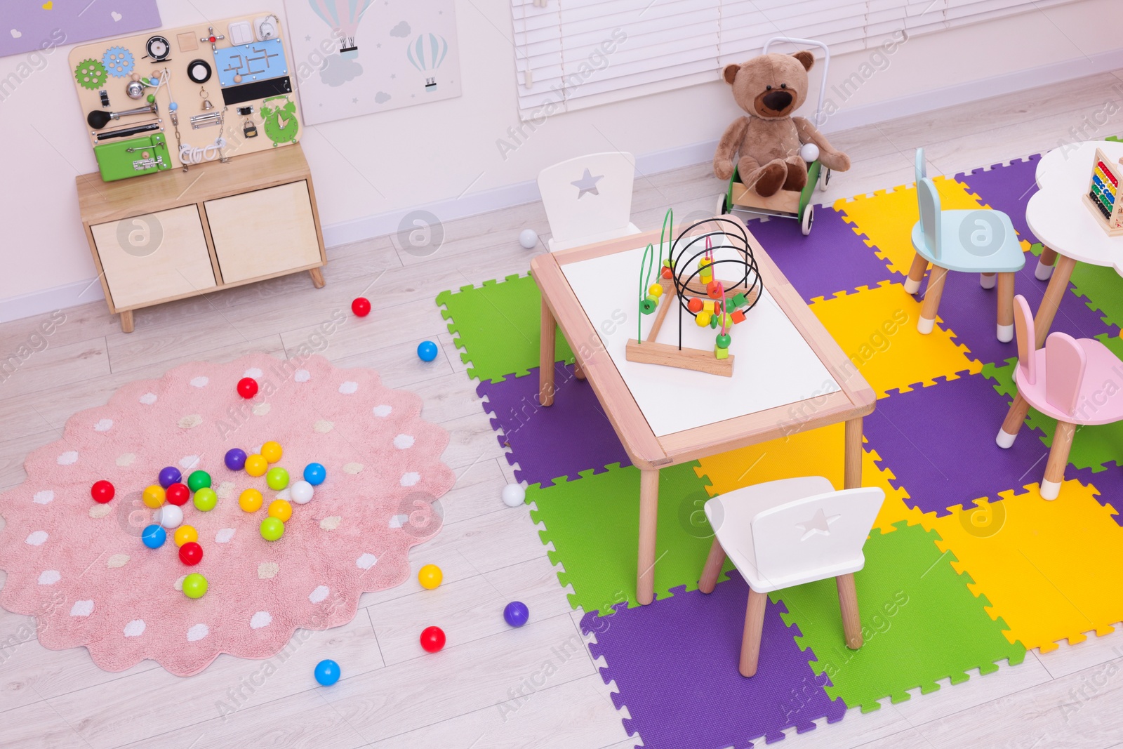 Photo of Stylish kindergarten interior with toys and modern furniture, above view