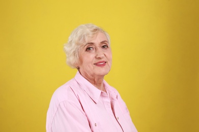 Senior woman in casual outfit on yellow background