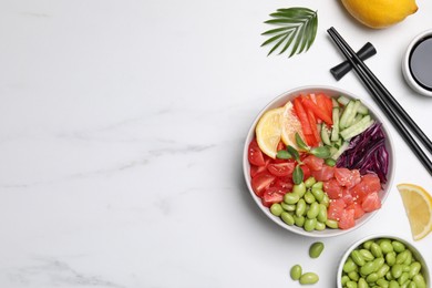 Photo of Poke bowl with salmon, edamame beans and vegetables on white marble table, flat lay. Space for text