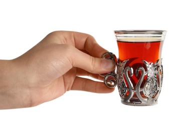 Photo of Woman holding glass of traditional Turkish tea in vintage holder on white background, closeup