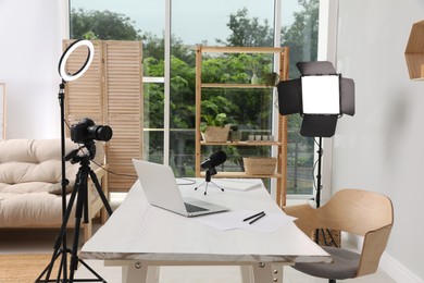 Photo of Modern blogger's workplace with professional equipment and laptop in room