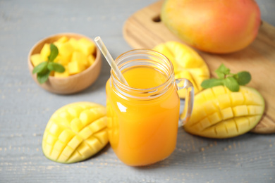 Fresh delicious mango drink on wooden table