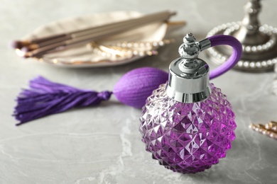 Photo of Vintage bottle of perfume on dressing table, closeup. Space for text