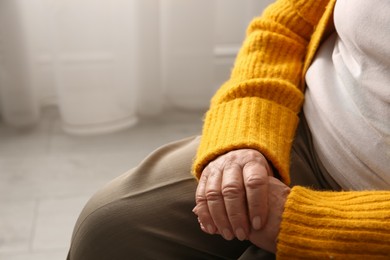 Photo of Elderly woman at home, closeup. Space for text