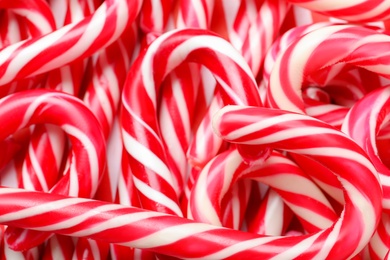 Photo of Many sweet Christmas candy canes as background, closeup