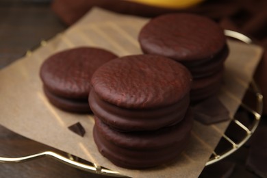 Photo of Delicious choco pies on wooden table, closeup