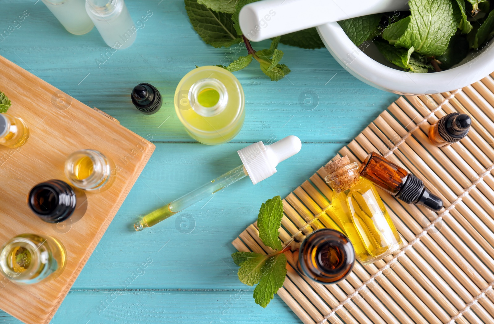 Photo of Composition with bottles of essential oils on table