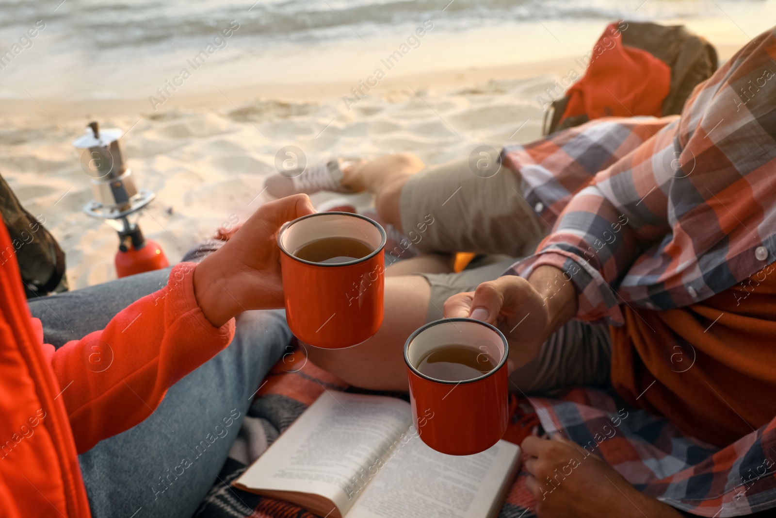 Photo of Couple resting in camping tent near sea, closeup