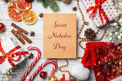 Saint Nicholas Day. Christmas decor and card on wooden background, flat lay