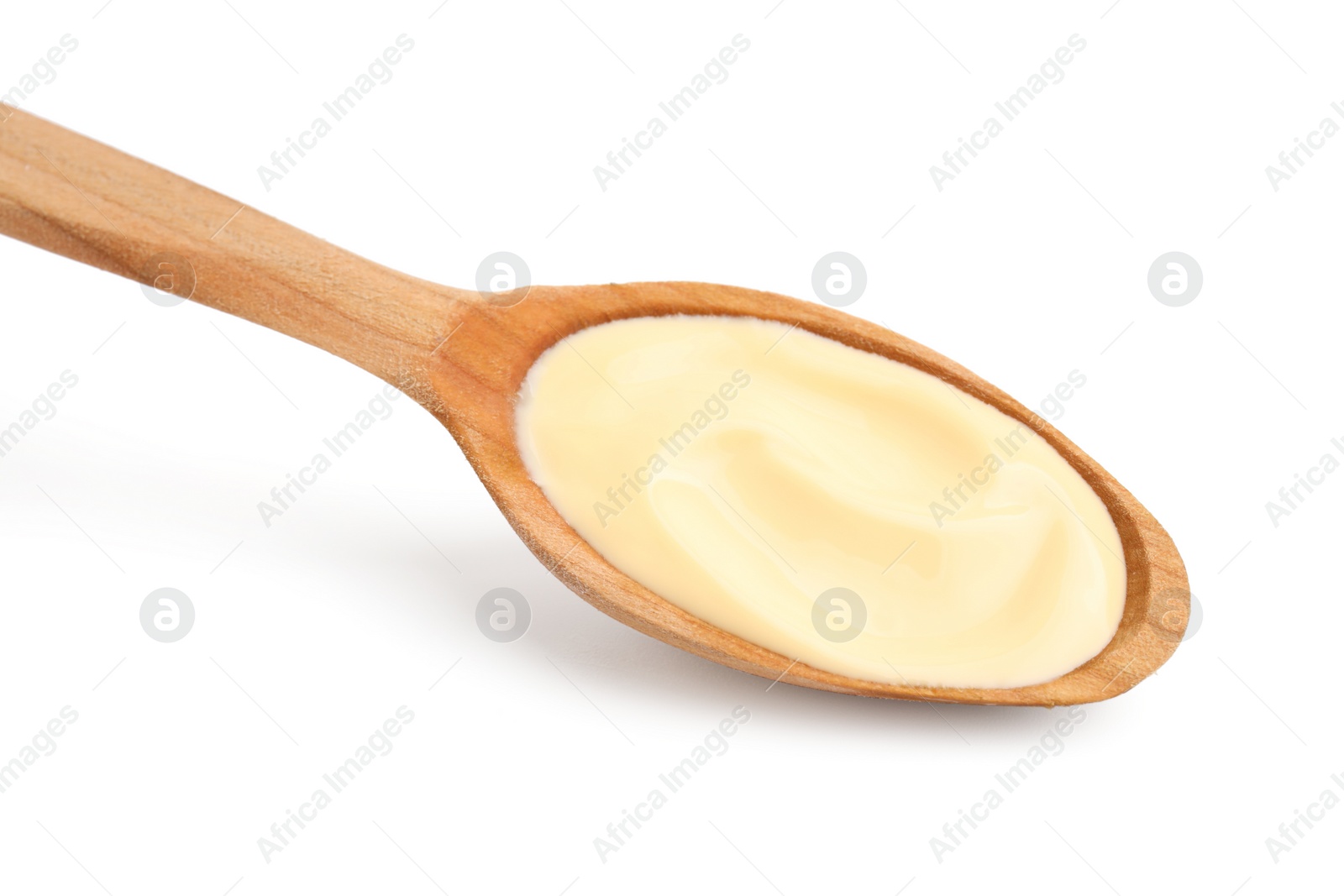 Photo of Wooden spoon with delicious cheese sauce isolated on white