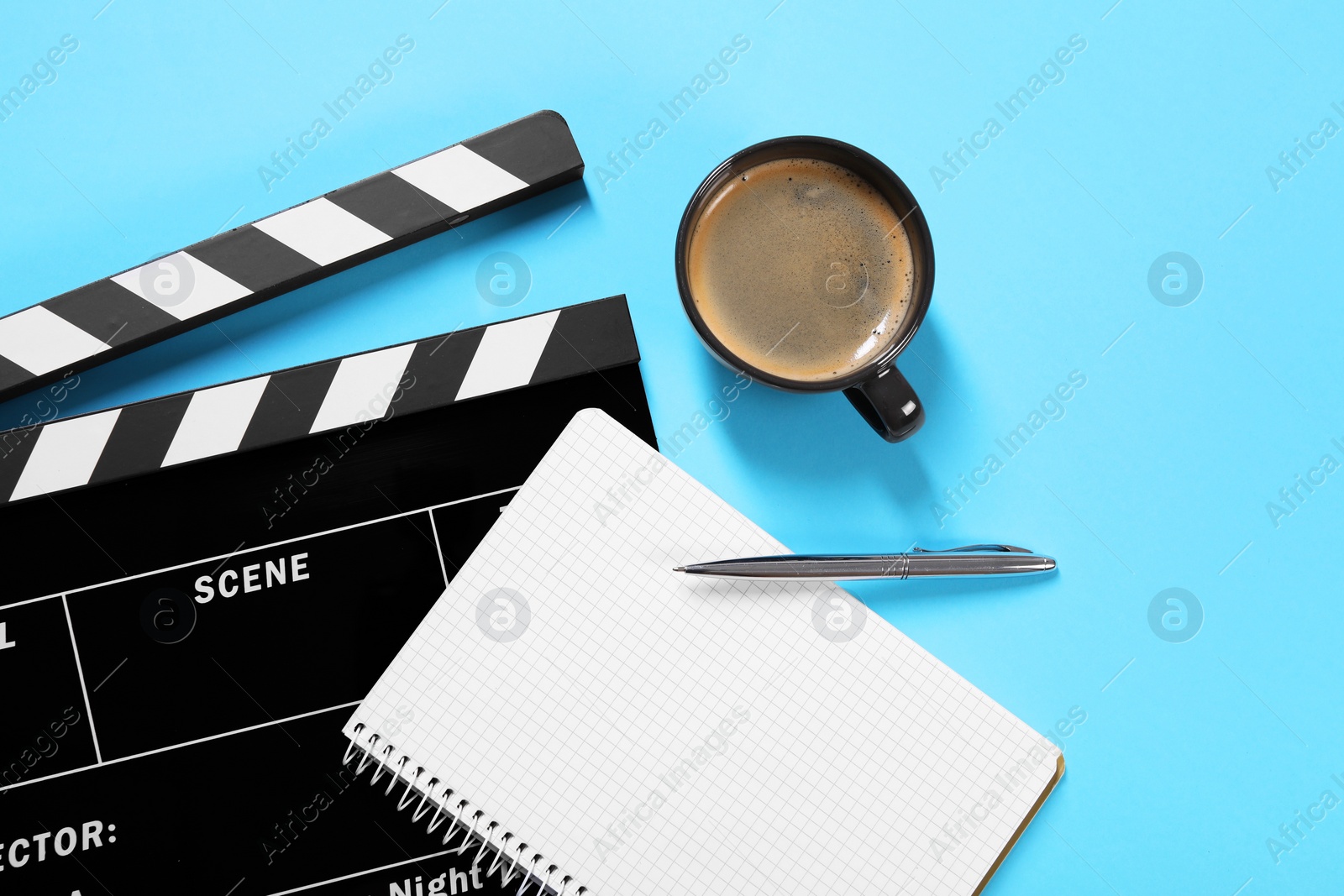 Photo of Movie clapper, coffee, notebook and pen on light blue background, flat lay