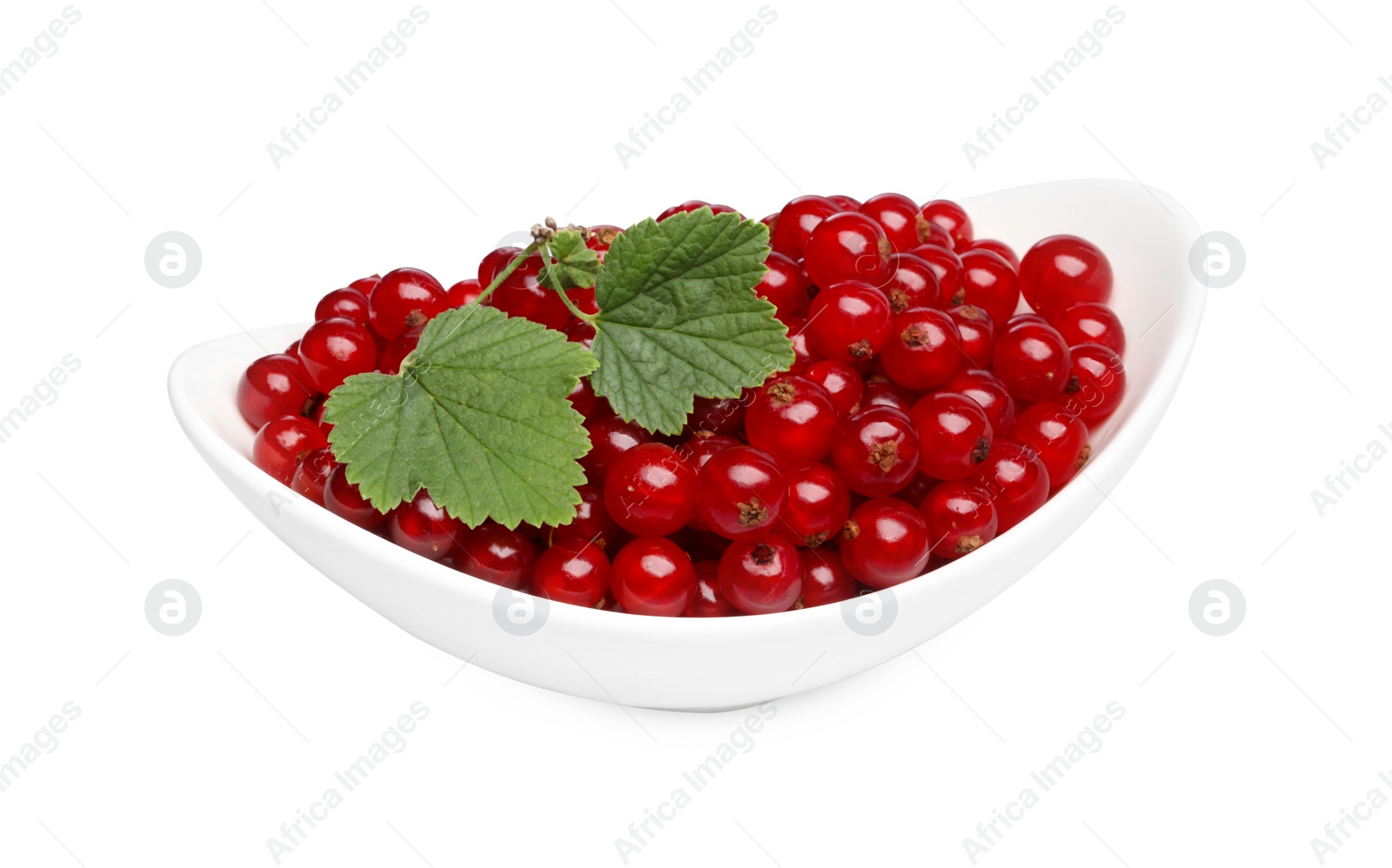 Photo of Many tasty fresh redcurrants and green leaves in bowl isolated on white