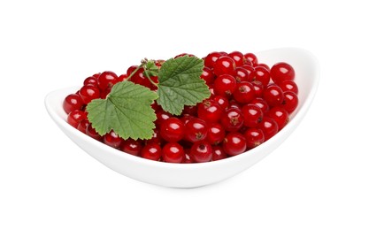 Photo of Many tasty fresh redcurrants and green leaves in bowl isolated on white