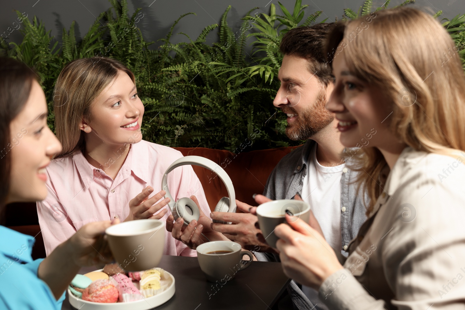 Photo of Friends with coffee spending time together in cafe