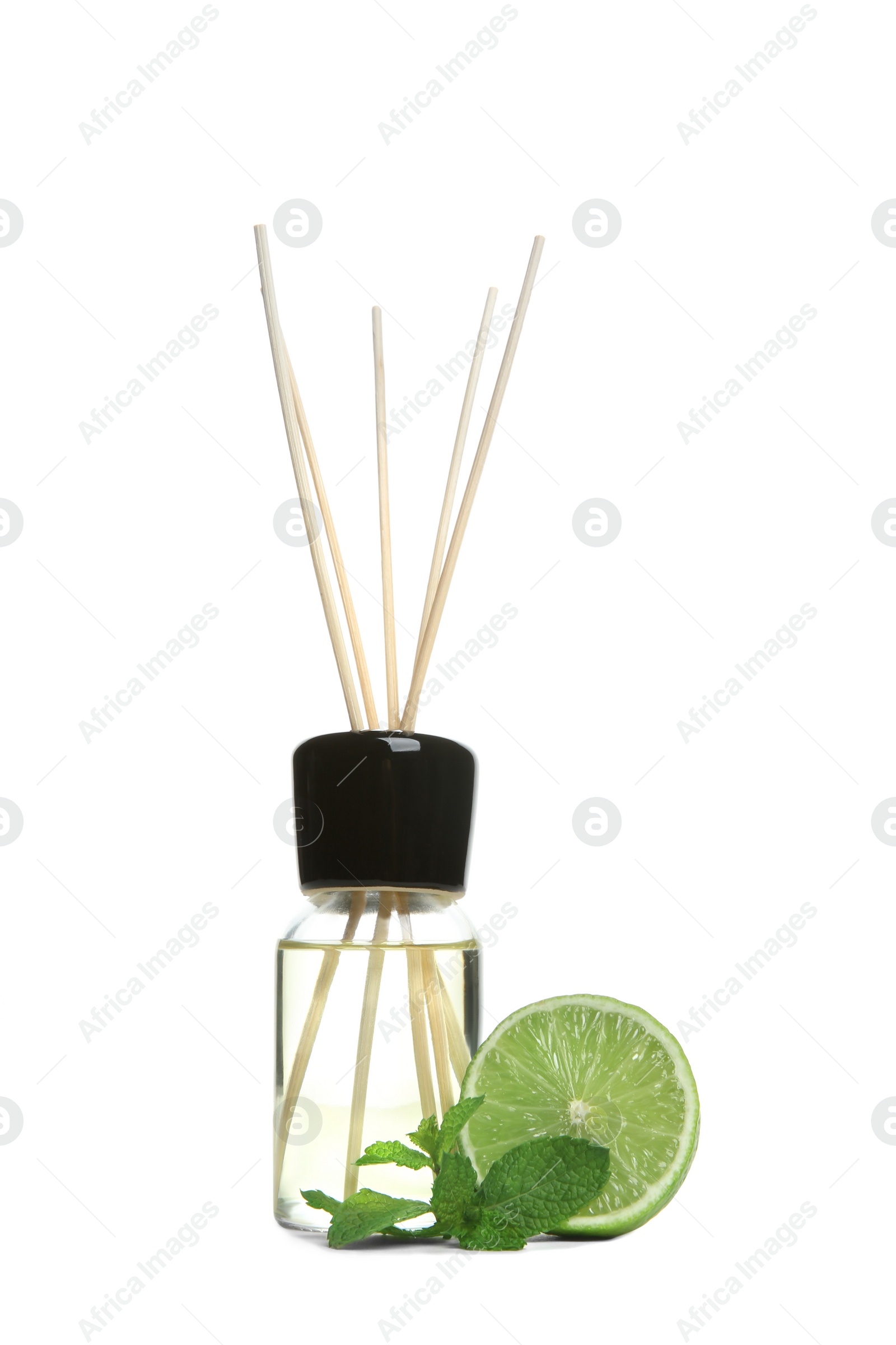 Photo of Aromatic reed air freshener and lime on white background