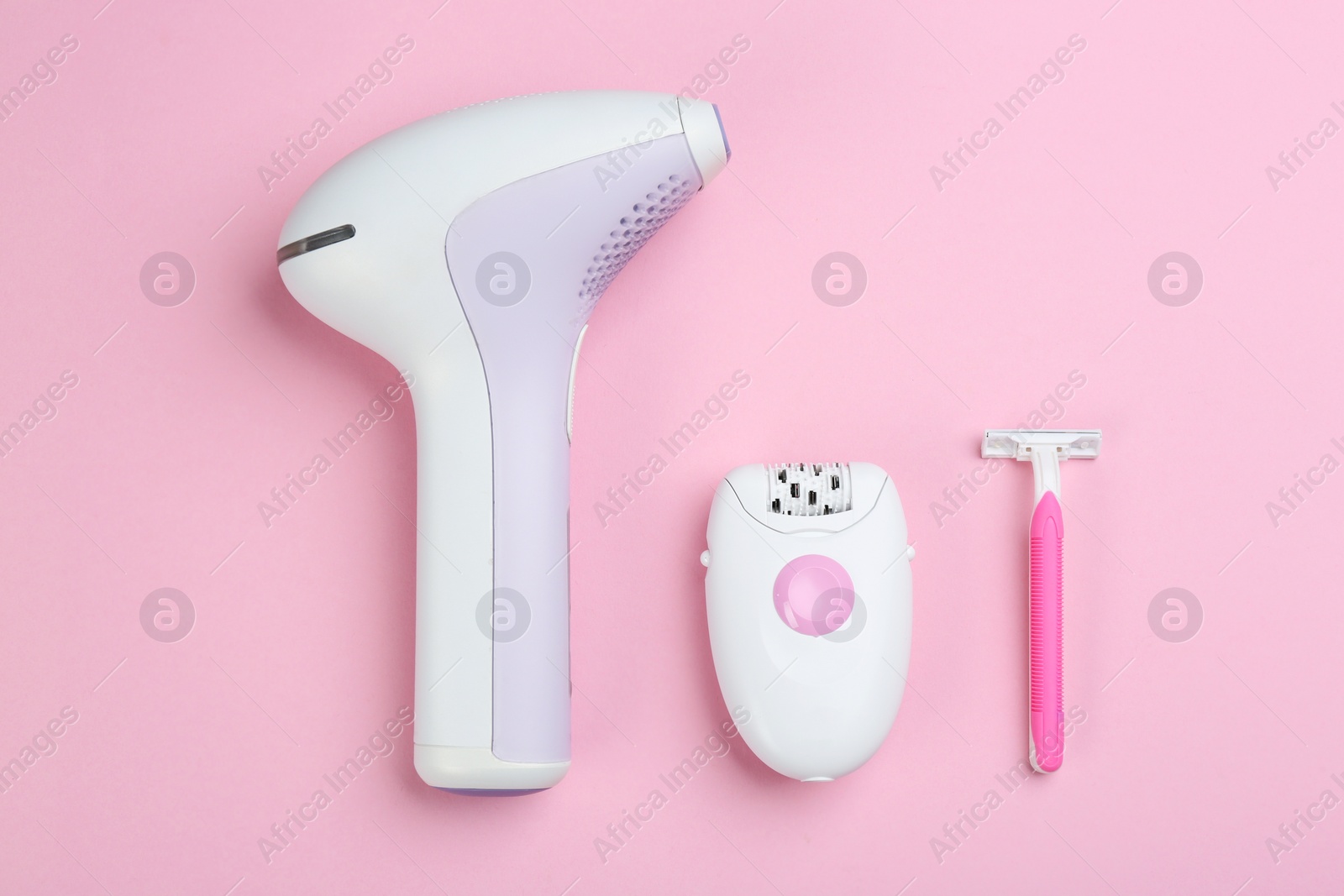 Photo of Flat lay composition with different tools for epilation on pink background