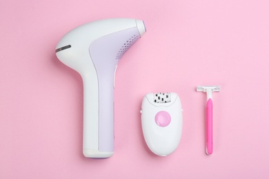 Flat lay composition with different tools for epilation on pink background