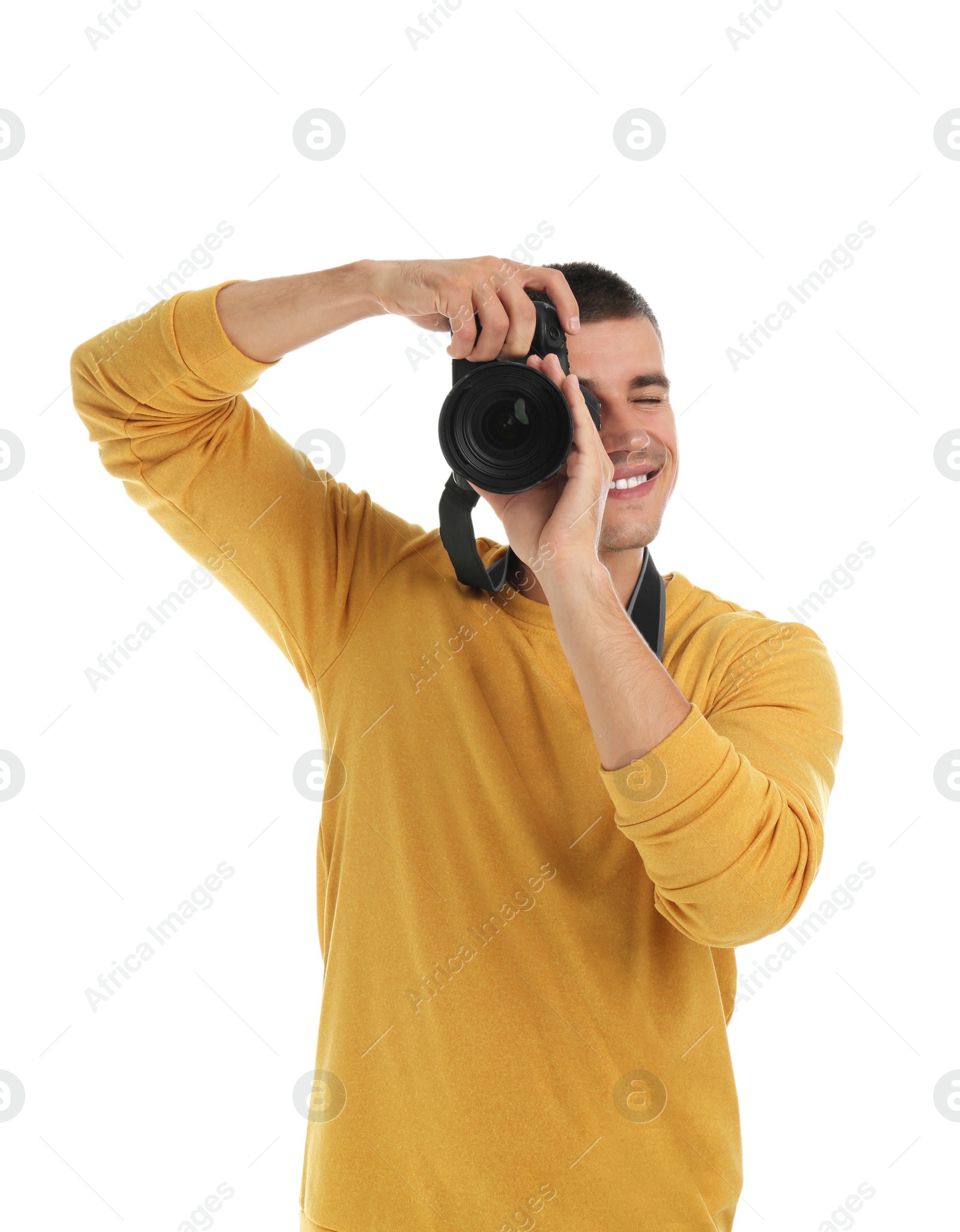 Photo of Young professional photographer taking picture on white background