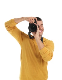 Young professional photographer taking picture on white background