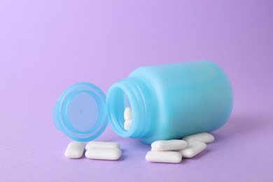 Photo of Jar with chewing gums on lilac background