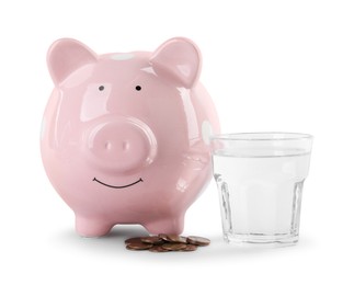 Water scarcity concept. Piggy bank, glass of drink and coins isolated on white
