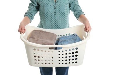 Young woman holding laundry basket with clothes on white background, closeup