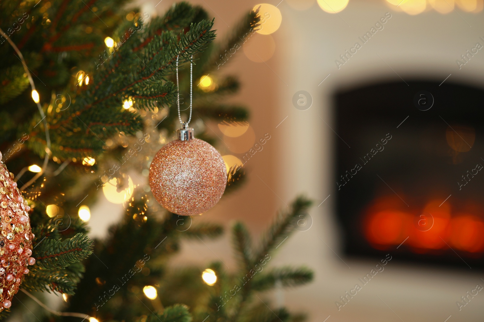 Photo of Beautiful Christmas tree decorated with festive lights and baubles indoors, space for text. Bokeh effect