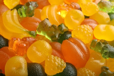 Mix of different delicious gummy candies as background, closeup