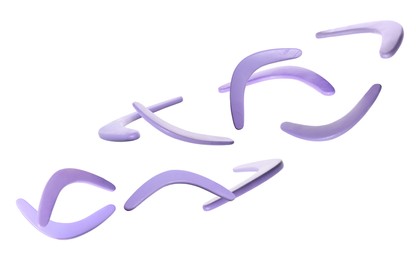 Image of Many violet boomerangs flying on white background 