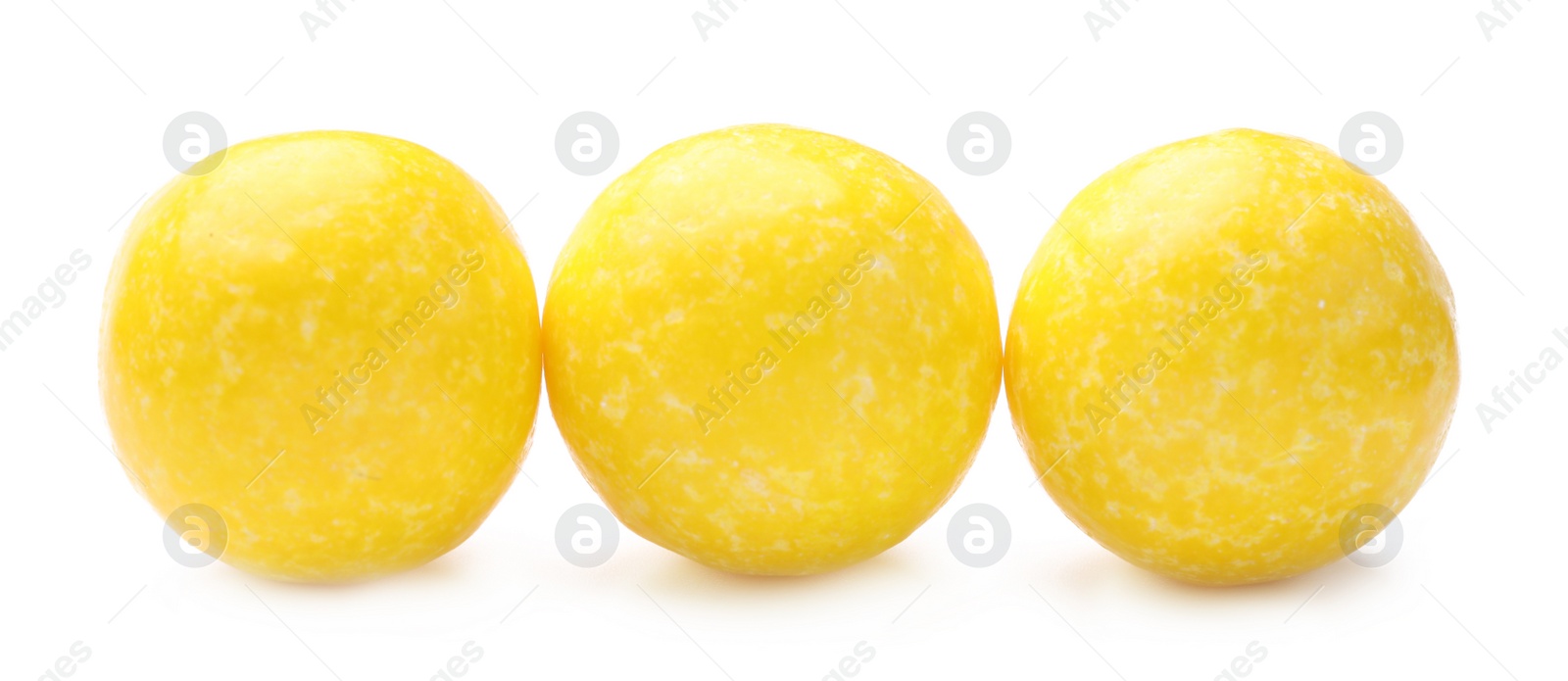 Photo of Tasty small lemon drops isolated on white