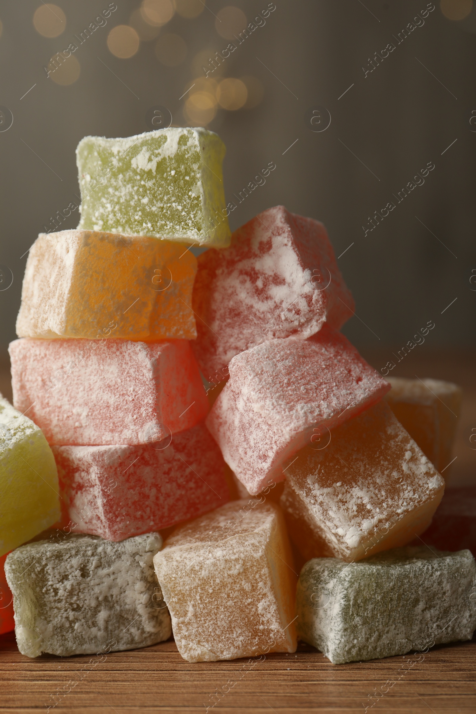 Photo of Turkish delight dessert on wooden table, closeup