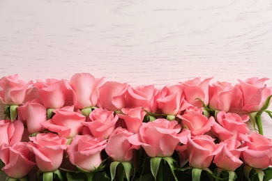 Beautiful roses on wooden table